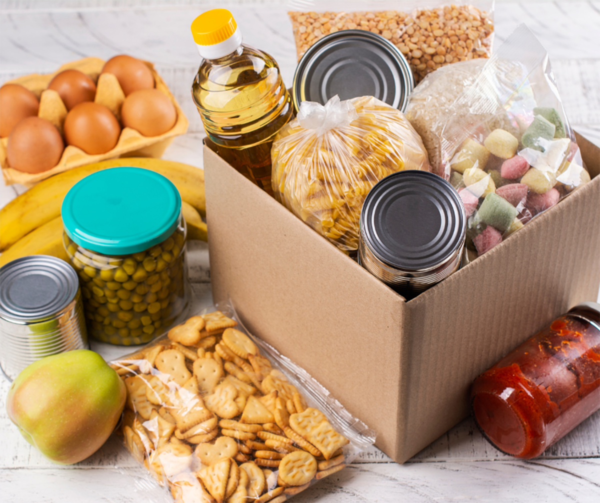 Box of food stables surrounded by additional food.