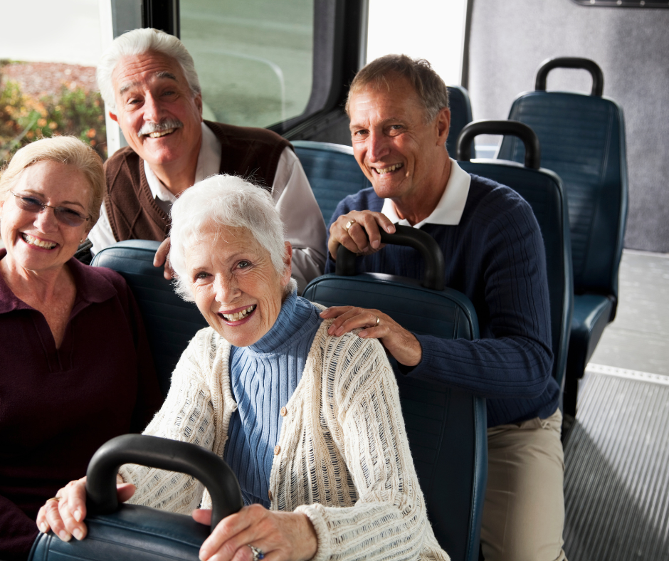 Two female and two male older adults riding a public bus.