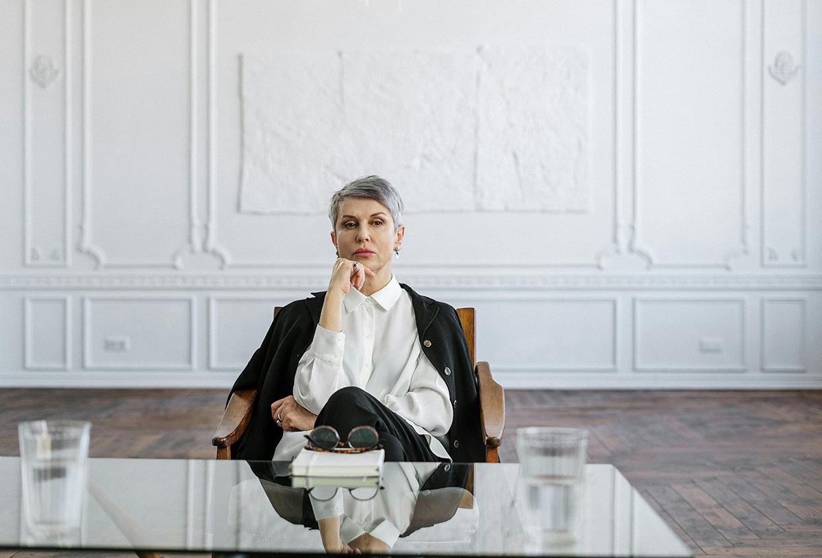 Older woman in business suit sitting in board room