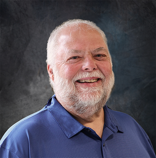 Older adult male smiling at the camera