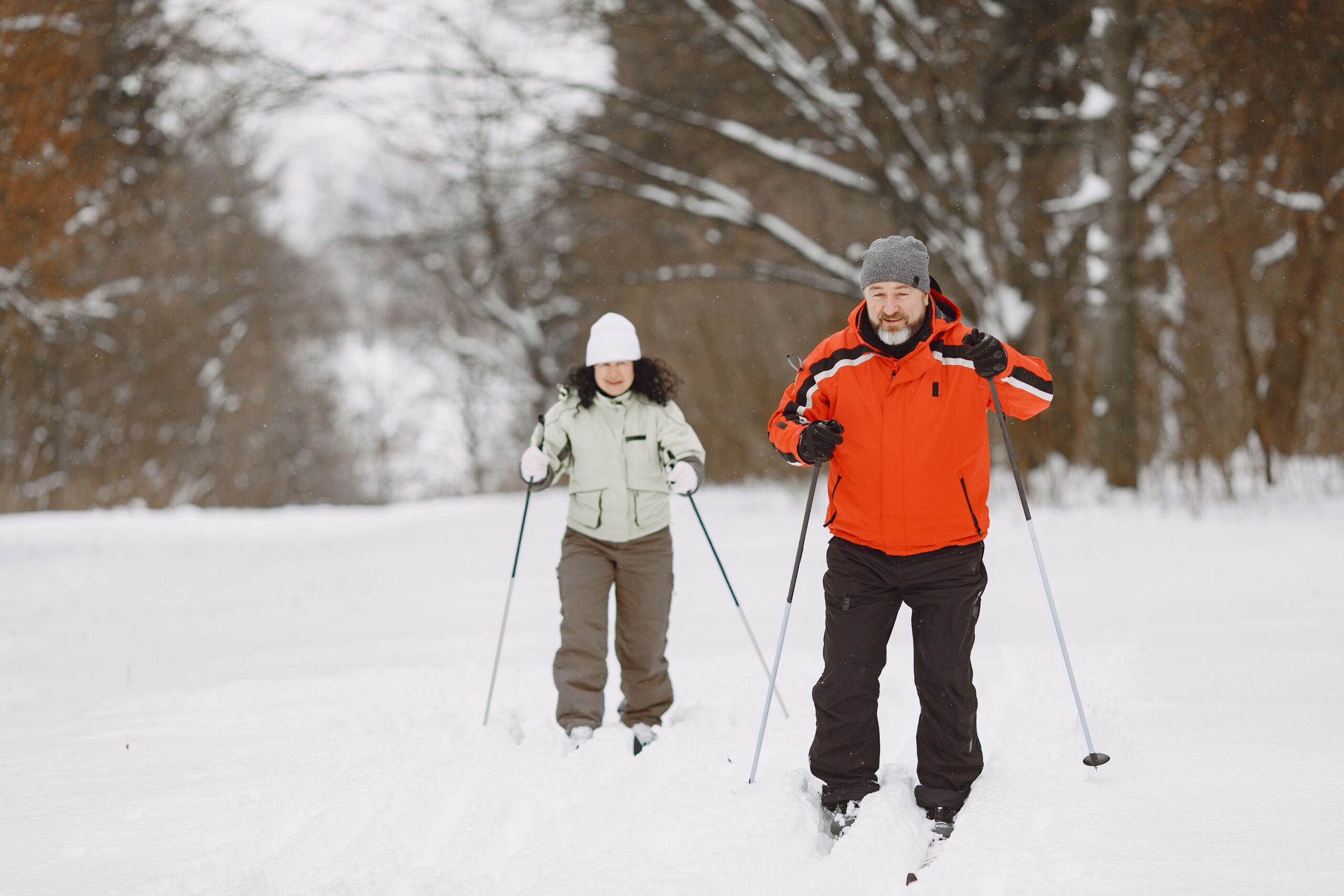 A male and female cross country skiing
